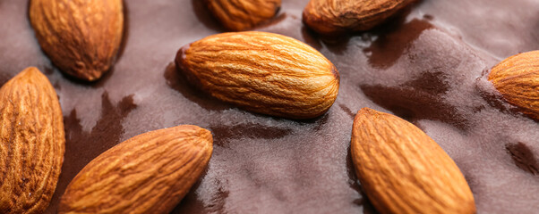 Tasty liquid chocolate with almonds, closeup
