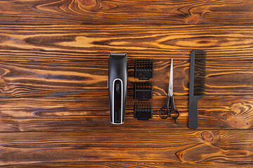 Hairdresser tools on wooden background. Haircut accessories concept. Top view