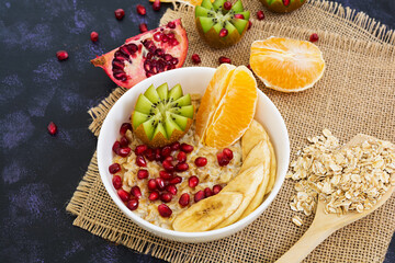 Healthy breakfast. Oatmeal with fruit on dark background