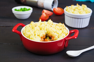 Homemade shepherd's pie on wooden background