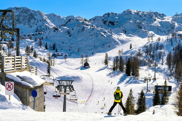 People skiing in Vogel, Slovenia. Sunny weather in the mountains on a perfect ski slope. Slopes in...