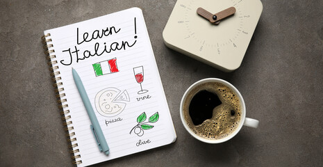 Notebook with text LEARN ITALIAN, clock and cup of coffee on grey background, top view