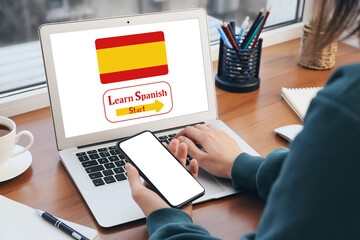 Young woman studying Spanish online at home