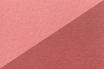 Texture of craft maroon and rose paper background, half two colors, macro. Vintage dense kraft pink cardboard.