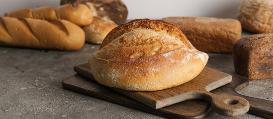Loaf of fresh bread on grunge background