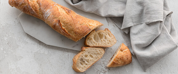 Fresh French baguette on grunge background