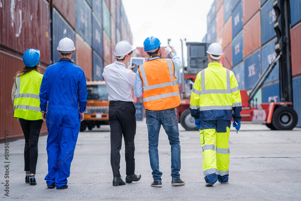 Poster Engineer and foreman team in hardhat checking stock into container for loading from cargo at container yard,Import export shipping concept.