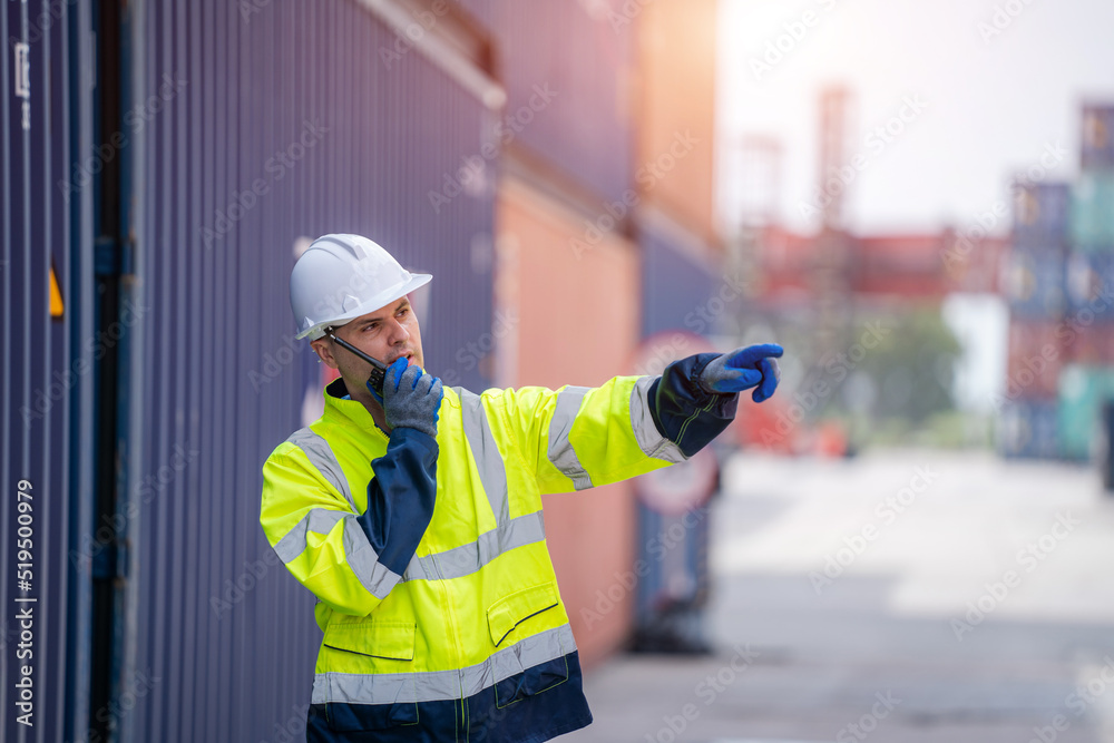 Poster Technicians using walkie talkie checking stock for loading in the container yard warehouse,Logistic shipping yard business.