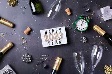 Happy New Year greeting card, 2023 with champagne, confetti
