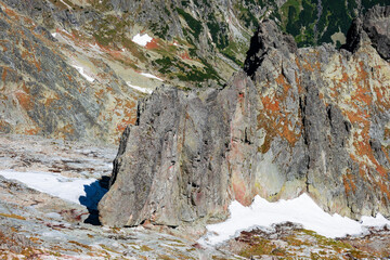 Snow on the rocks in the Tatra mountains in the summer season