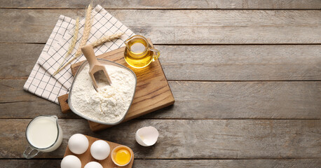 Ingredients for baking on wooden background with space for text