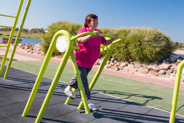 Fototapeta premium Grandma regularly plays outdoor sports and is doing well in her seventies, an active lifestyle, healthy diet and regular exercise keep her in good shape.