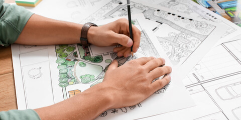 Young male landscape designer working in office, closeup