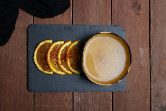 top view of gourd with mezcal and orange slices