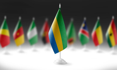 The national flag of the Gabon on the background of flags of other countries