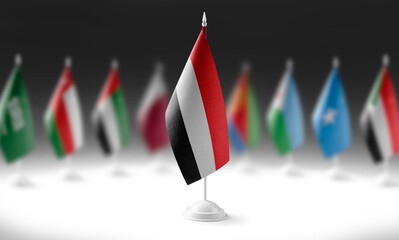 The national flag of the Yemen on the background of flags of other countries