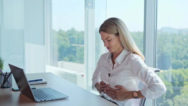 Stomach pain. Female hands touching stomach. Diarrhea, constipation, irritable bowel. Office employee suffering stomach pain and nausea, poisoning unhealthy nutrition. Adult businesswoman feeling bad.