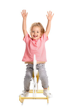 Cute little girl with rocking horse on white background