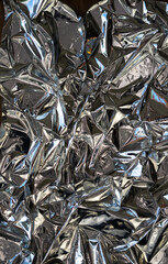 Blank glued aluminum foil texture for background and wallpaper. Crumpled abstract texture surface...