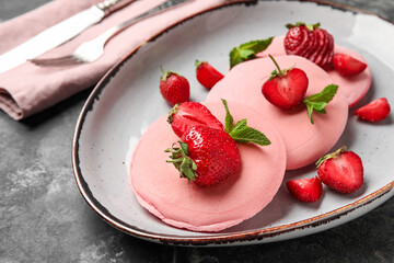 Plate of tasty pancakes with strawberry on grunge background, closeup