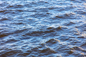Wavy surface of water in a reservoir as an abstract background.