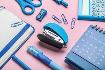 Stapler with different stationery supplies on pink background - obrazy, fototapety, plakaty