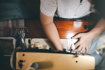 Retriement tailor southeast asian elderly crafting a cloth by sewing machine working at home