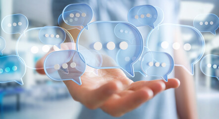 Businessman using digital speech bubbles talk icons. Minimal conversation or social media messages floating over user hand. 3D rendering © sdecoret