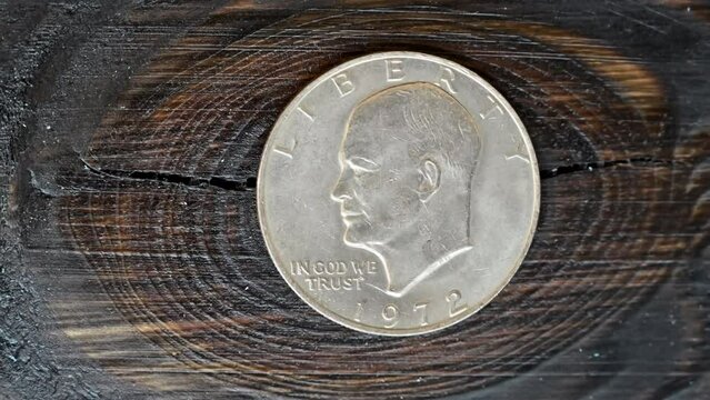 One dollar 1972 coin macro close up on wooden background