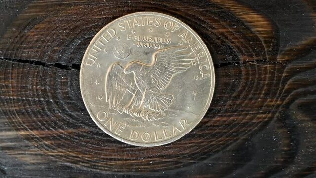 One dollar 1972 coin macro close up on wooden background