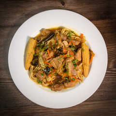 Recipe for wok-cooked pork loin with black mushroom and chinese noodle, corn on the cob, carrot, caramel sauce, soy, nuoc mam, ginger, High quality photo