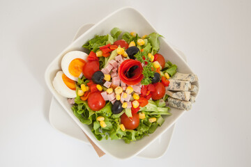 Close up of vegetables salad with ham and eggs