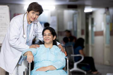 Doctor consulting with senior person in wheelchair