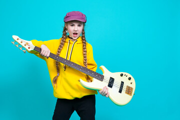 Winsome Caucasian Female Guitar Player With White Bass Guitar Holding Instrument Lifted Nearby And...