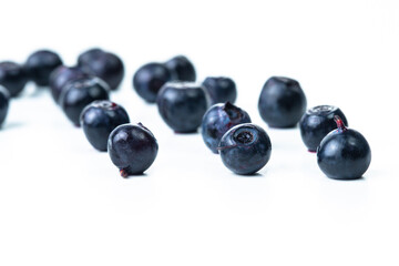 Organic Food Concepts. Variety of Fresh Forest Blueberries With Shallow Depth of Field Isolated on white