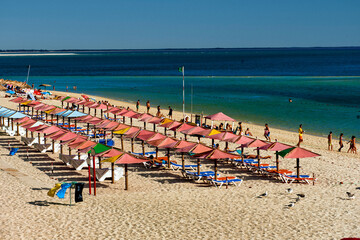 parasol and beach chairs on Figueirinha beach, in the district of Setubal, Portugal