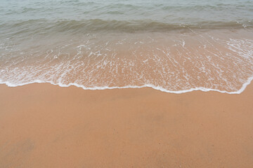 Fototapeta na wymiar Beautiful tropical seascape - Waves at tropical beach with copy space. 