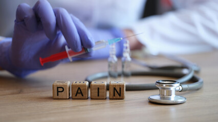 Female doctor hand in glove holding injection syringe with painkiller medicine