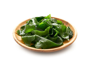 Laminaria (Kelp) Seaweed in wood plate Isolated on White Background. fresh Laminaria or kelp Seaweed in a wooden dish Isolated on White Background. konbu, alga               