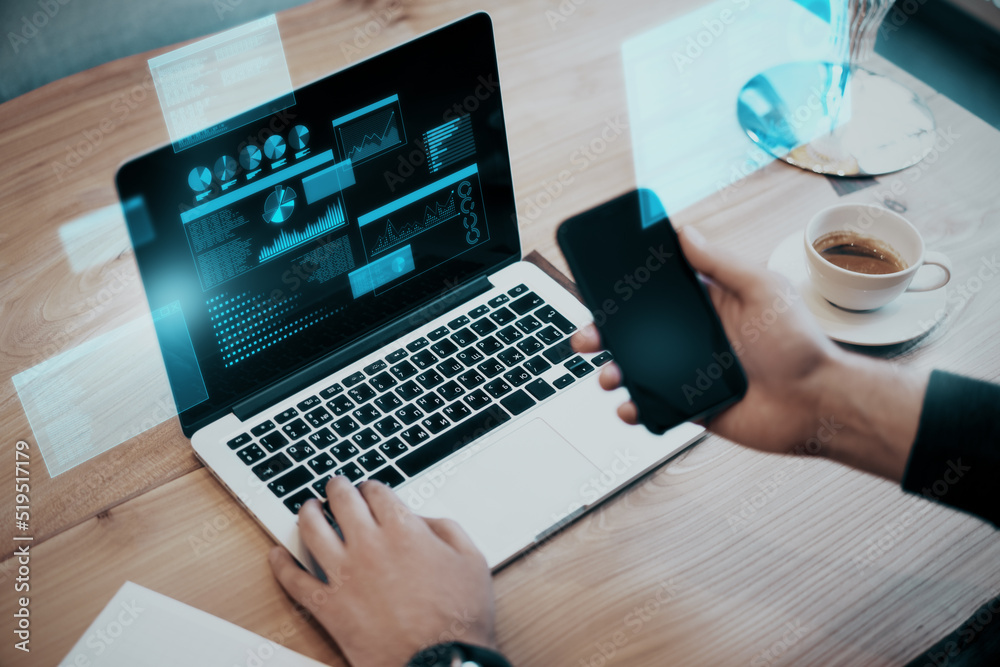 Poster businessman hands using laptop keyboard and smaertphone with glowing business chart hologram on scre