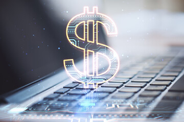 Close up of laptop with creative glowing dollar sign hologram on blurry background. Online banking, technology and currency concept. - obrazy, fototapety, plakaty