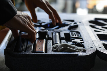 Close-up shot of videographer's hands preparing the Gimbal Stabilizers or equipment for filmmaking.
