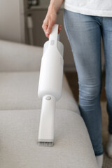 Woman cleaning at home using cordless vacuum