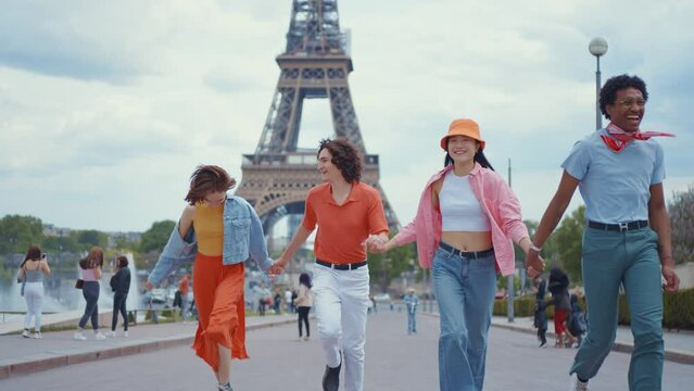 Video of an happy group of millennial teenagers spending time in Paris around the eiffel tower area
