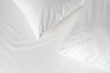 Hypoallergenic pillows with memory foam material on white bedsheet