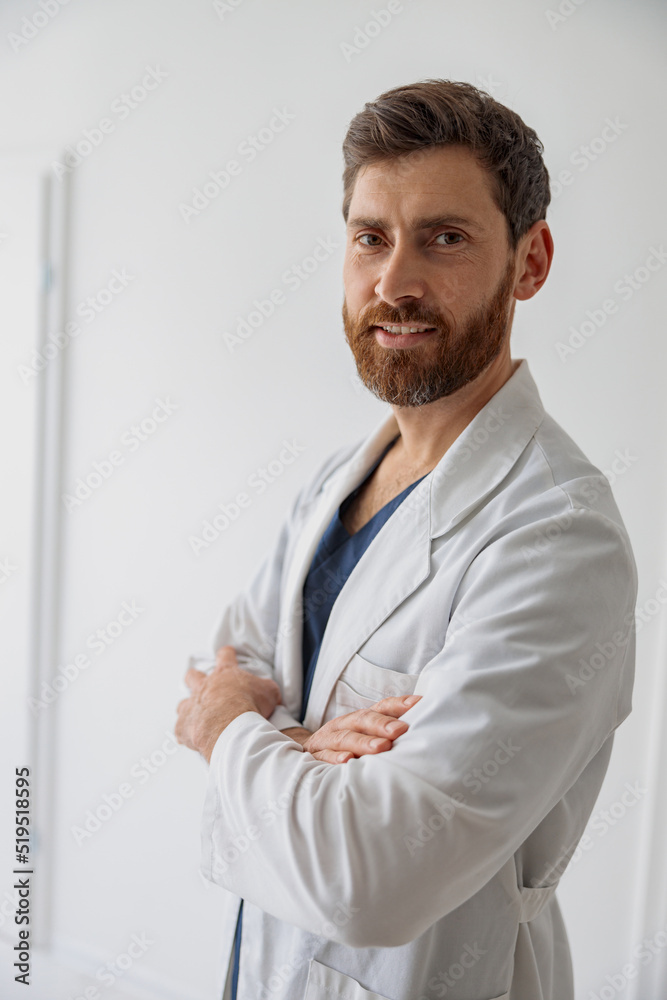 Sticker portrait of handsome doctor in uniform standing in medicine clinic hall and looking camera