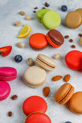Fototapeta premium Colorful french dessert macarons with fresh fruits and nuts.