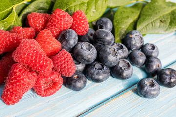 Berries on a wooden background. Summer or spring Organic berry. Strawberries, Raspberries, Blueberries. Agriculture, Gardening, Harvesting Concept.