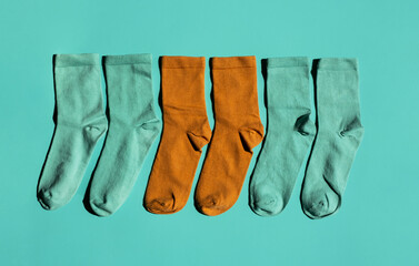 Some socks on turquoise background. Layout colourful socks.