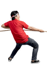 Indonesian men celebrate Indonesian independence day on 17 August with the tug of war contest